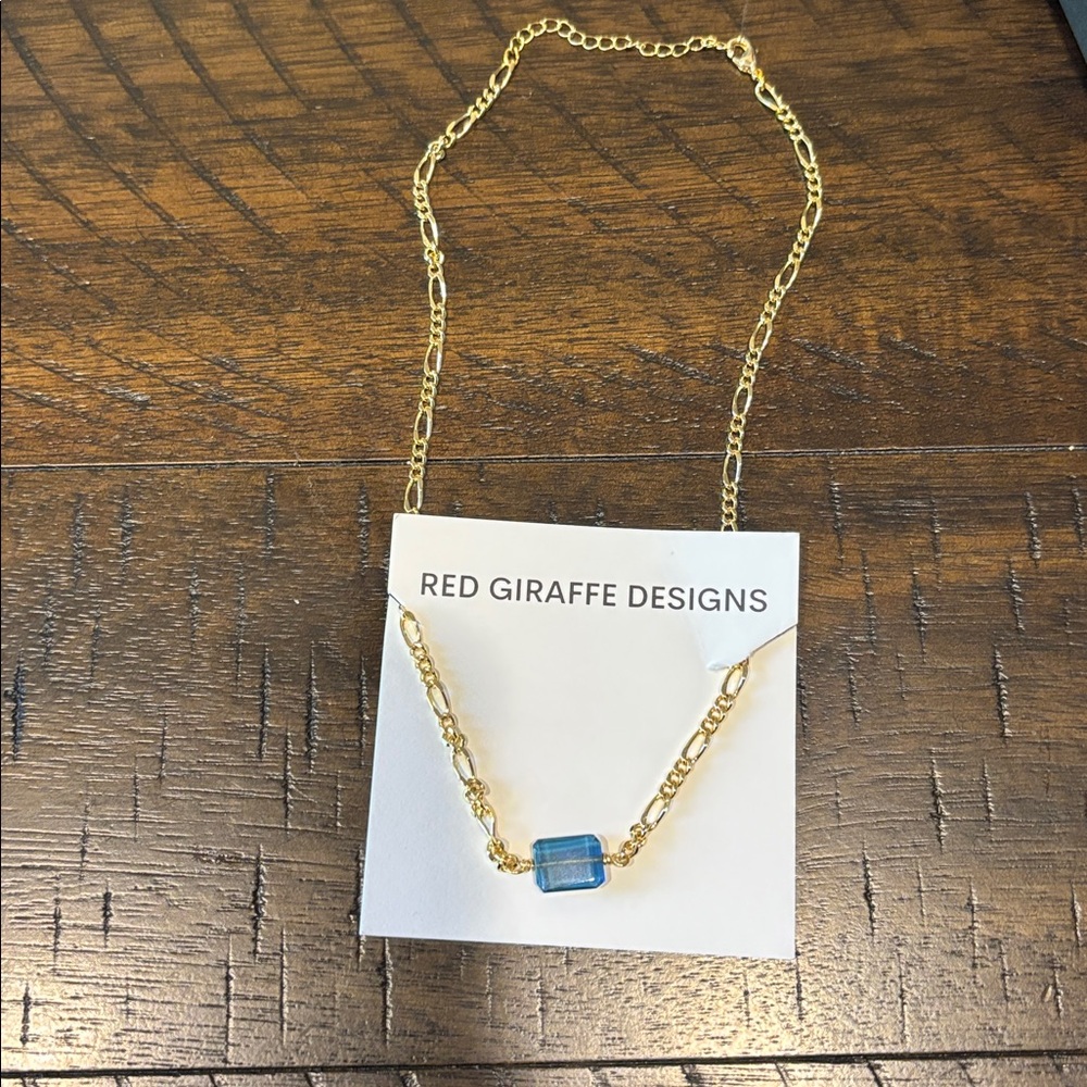 Red Giraffe Designs Chocker Necklace with Blue Charm. New in box- never worn